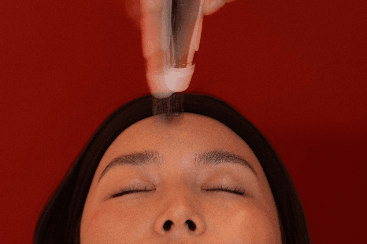 Microneedling pen in front of red background.